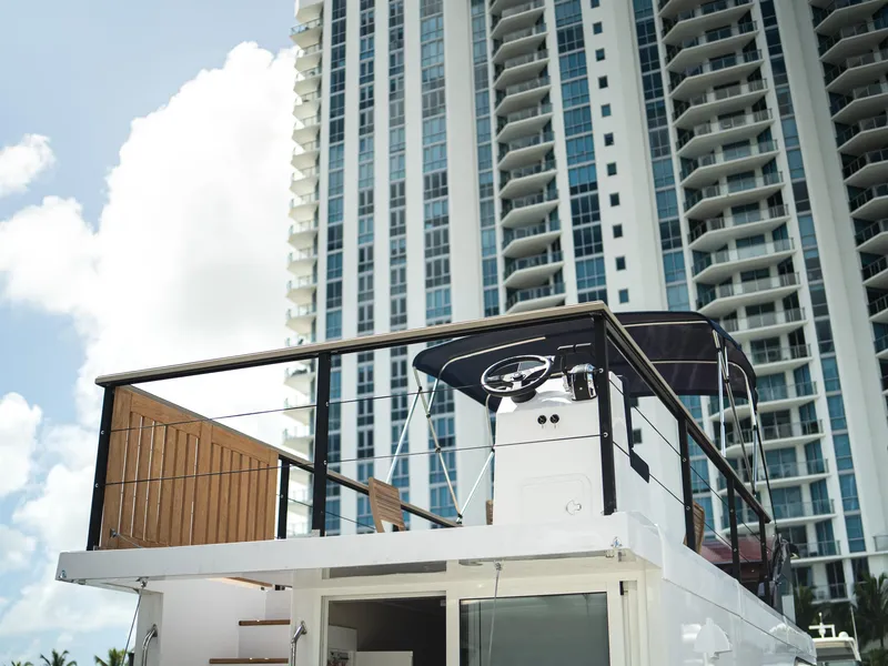 Slide: The Image of Modern 2024 Navisyo Homes 28' NAVIS V.08 houseboat with city skyscraper backdrop. - 34