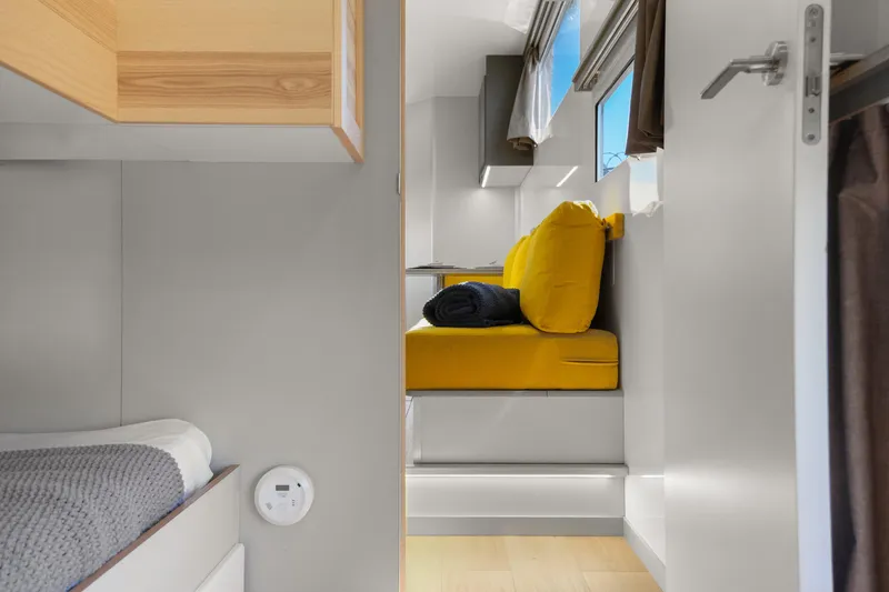 Slide: The Image of Interior of 2024 Navisyo Homes 28' NAVIS V.08 with modern seating and bright decor. - 43