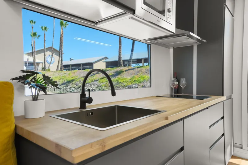Slide: The Image of Modern kitchen interior of 2024 Navisyo Homes 28' NAVIS V.08 with scenic window view. - 44