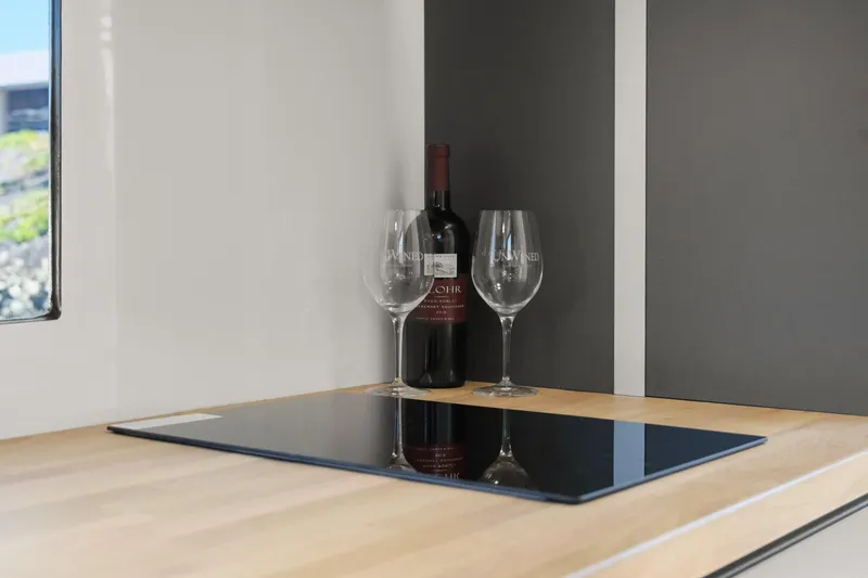 Slide: The Image of Modern kitchen counter with wine bottle and glasses, Navisyo Homes 28' NAVIS V.08, 2024 model. - 46