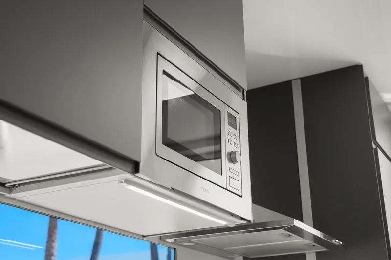 Slide: The Image of Modern kitchen with built-in microwave in 2024 Navisyo Homes 28' NAVIS V.08. - 48