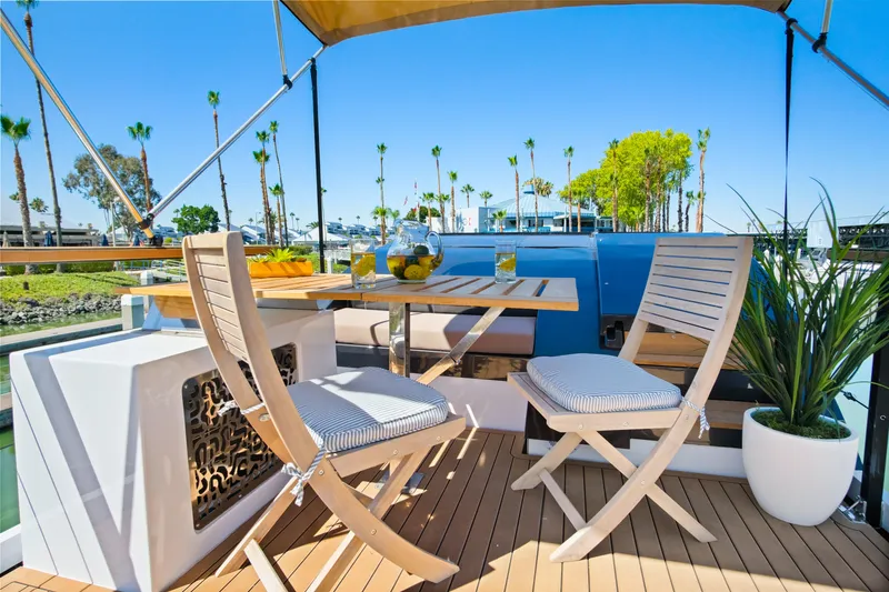 Slide: The Image of Luxurious 2024 Navisyo Homes 28' NAVIS V.08 yacht deck with elegant seating and scenic view. - 7