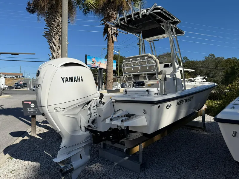 Slide: The Image of 2025 Key West 210 Bay Reef boat with Yamaha engine, parked outdoors. - 3