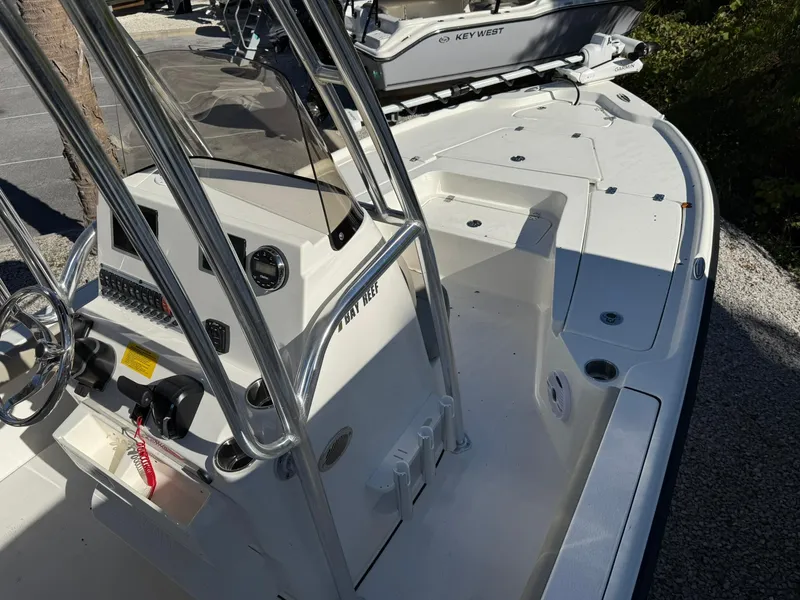 Slide: The Image of 2025 Key West 210 Bay Reef boat interior with steering console and seating area. - 4