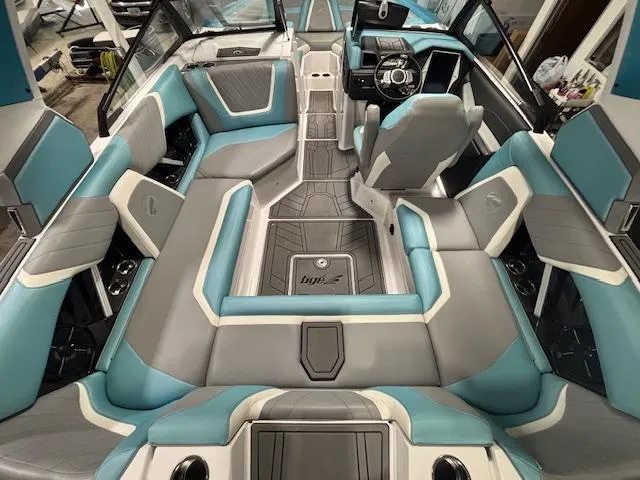 Slide: The Image of 2020 Tigé 20RZX boat interior with blue and gray seating, modern dashboard, and spacious layout. - 10