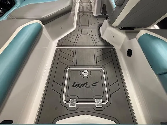 Slide: The Image of 2020 Tigé 20RZX boat interior with sleek gray and teal seating and flooring. - 11