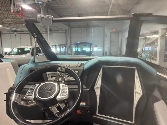 Slide: The Image of 2020 Tigé 20RZX boat dashboard with steering wheel and touchscreen display. - 13