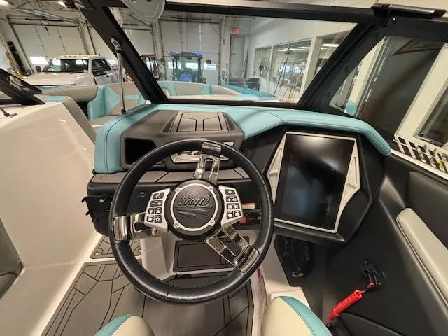 Slide: The Image of 2020 Tigé 20RZX boat interior with steering wheel and dashboard display. - 14