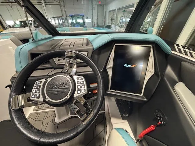 Slide: The Image of 2020 Tigé 20RZX boat dashboard with touchscreen and steering wheel. - 15