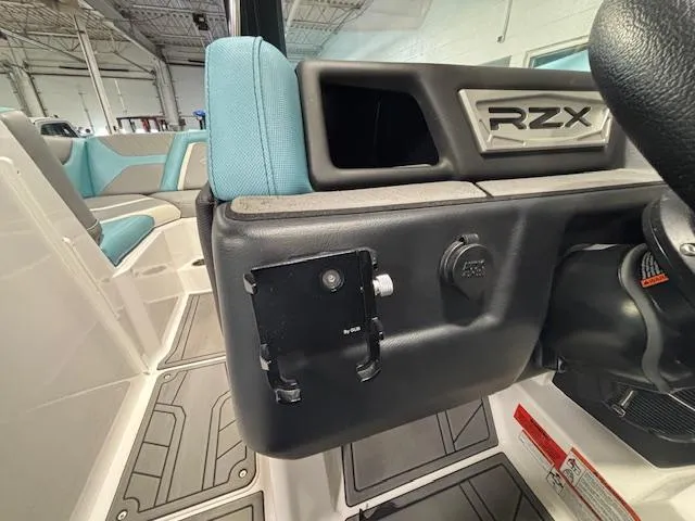 Slide: The Image of 2020 Tigé 20RZX boat interior with blue seating and dashboard details. - 17