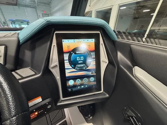 Slide: The Image of 2020 Tigé 20RZX dashboard with touchscreen display in a modern boat interior. - 18