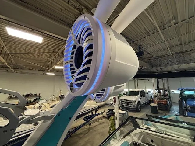 Slide: The Image of 2020 Tigé 20RZX boat with illuminated speaker in a garage setting. - 21
