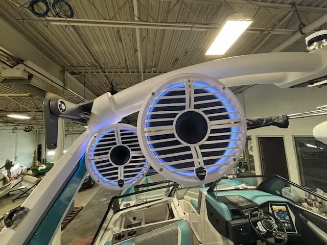 Slide: The Image of 2020 Tigé 20RZX boat with illuminated speakers in a garage setting. - 22