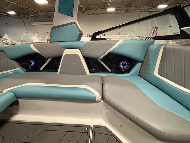 Slide: The Image of 2020 Tigé 20RZX boat interior with teal and gray seating, modern design. - 24