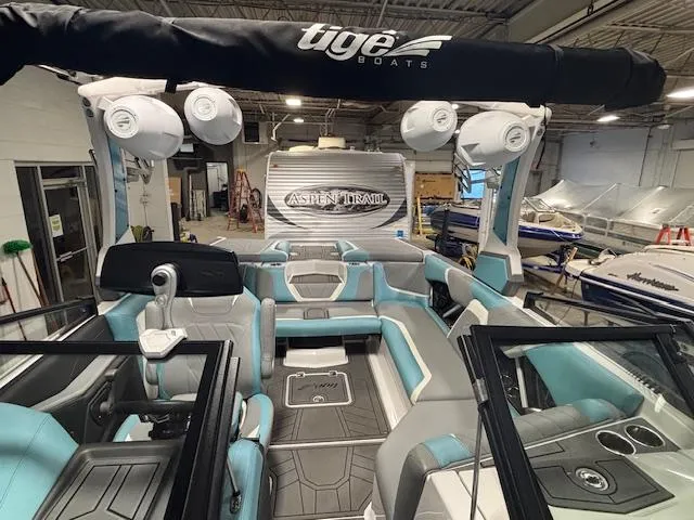 Slide: The Image of 2020 Tigé 20RZX boat interior with modern seating and sound system in a showroom. - 30