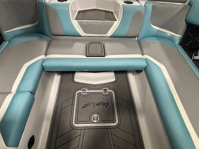 Slide: The Image of 2020 Tigé 20RZX boat interior with gray and teal seating and storage compartments. - 34