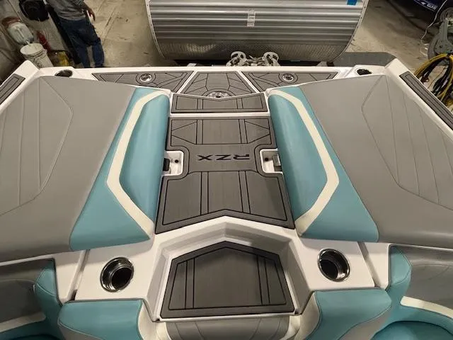 Slide: The Image of 2020 Tigé 20RZX boat interior with gray and blue seating and sleek design. - 36