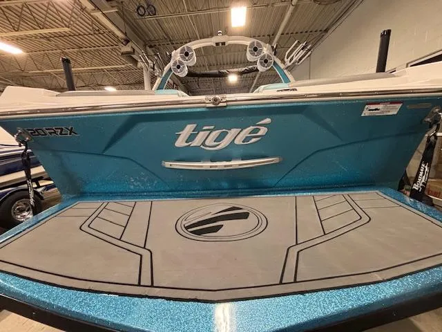 Slide: The Image of 2020 Tigé 20RZX boat with blue exterior in a warehouse setting. - 5