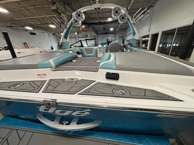 Slide: The Image of 2020 Tigé 20RZX boat with sleek design and modern interior in a showroom. - 6