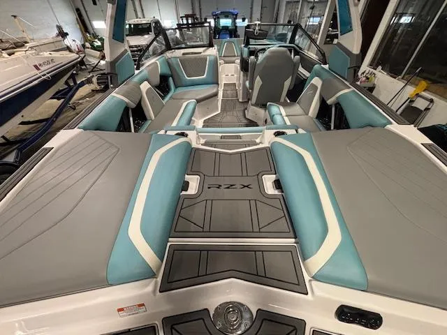 Slide: The Image of 2020 Tigé 20RZX boat interior with teal and gray seating, spacious layout. - 7