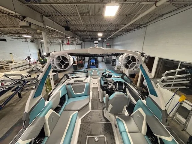 Slide: The Image of 2020 Tigé 20RZX boat interior with modern seating and sound system in a workshop. - 9