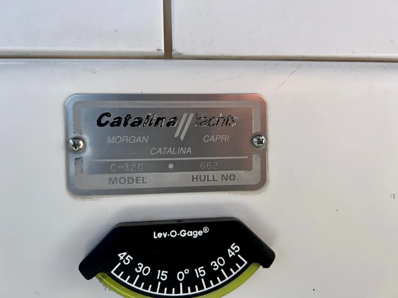 Slide: The Image of Catalina 320 yacht nameplate with model and hull number, featuring a Lev-O-Gage. - 29