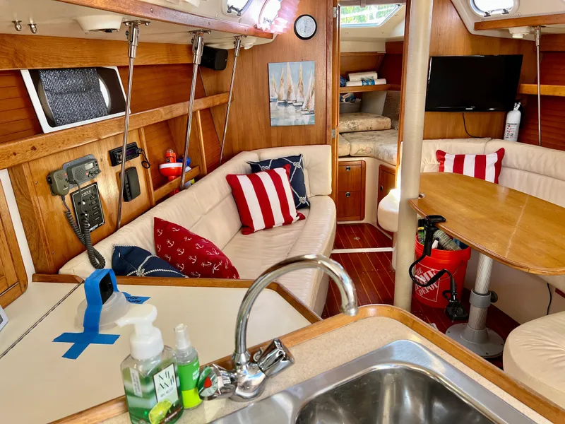 Slide: The Image of Interior of a 2000 Catalina 320 sailboat with cozy seating and nautical decor. - 33