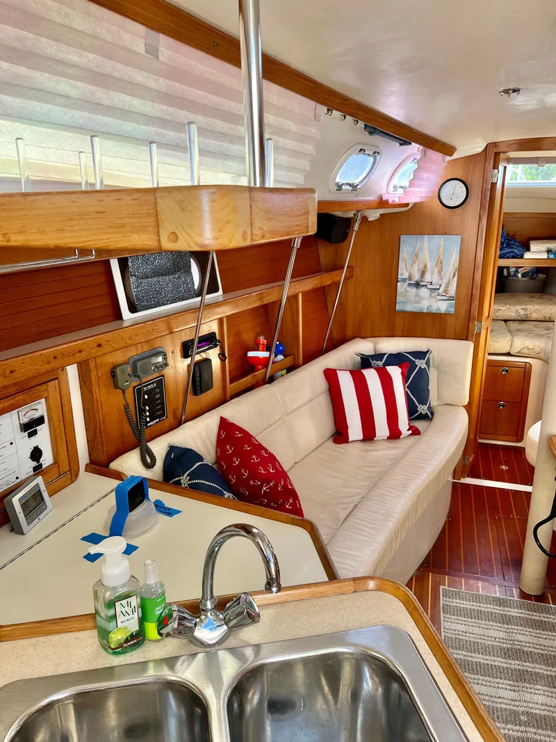 Slide: The Image of Interior of a 2000 Catalina 320 sailboat with cozy seating and nautical decor. - 35