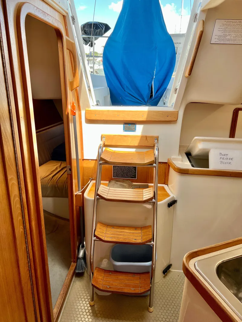 Slide: The Image of Interior of a 2000 Catalina 320 sailboat with wooden steps and cabin view. - 37