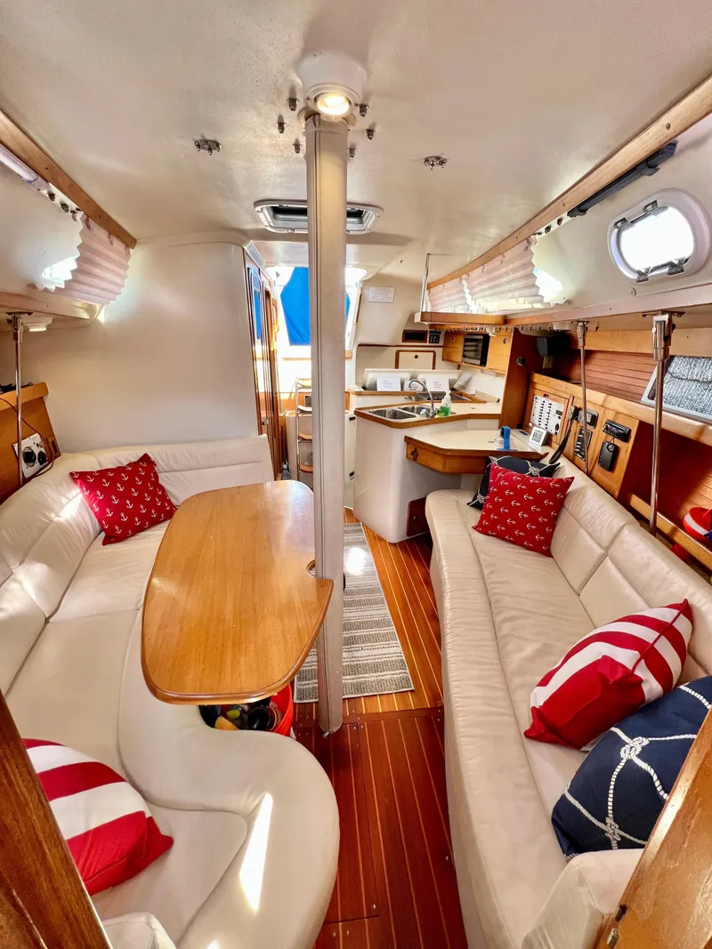 Slide: The Image of Interior of a 2000 Catalina 320 sailboat with cozy seating and nautical decor. - 42