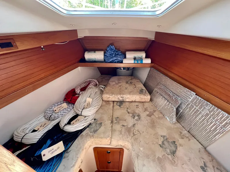 Slide: The Image of Cozy cabin interior of 2000 Catalina 320 sailboat with ropes and bedding. - 43