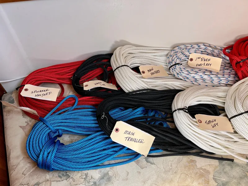 Slide: The Image of Coiled sailing ropes labeled for Catalina 320, 2000 model, including spinnaker halyard and main traveler. - 44