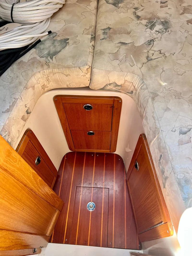 Slide: The Image of Interior cabin of 2000 Catalina 320 sailboat with wooden storage compartments. - 46