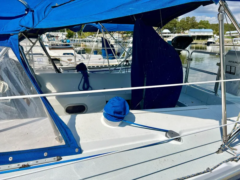 Slide: The Image of Cockpit of a 2000 Catalina 320 sailboat with blue canvas covers in a marina. - 9