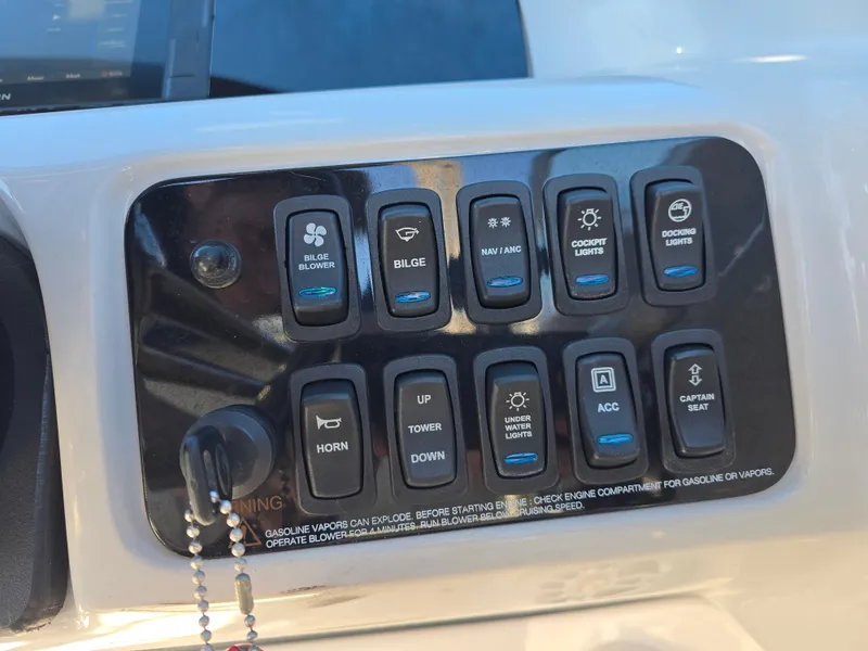 Slide: The Image of Control panel of a 2021 Regal LS2 boat with various switches. - 10