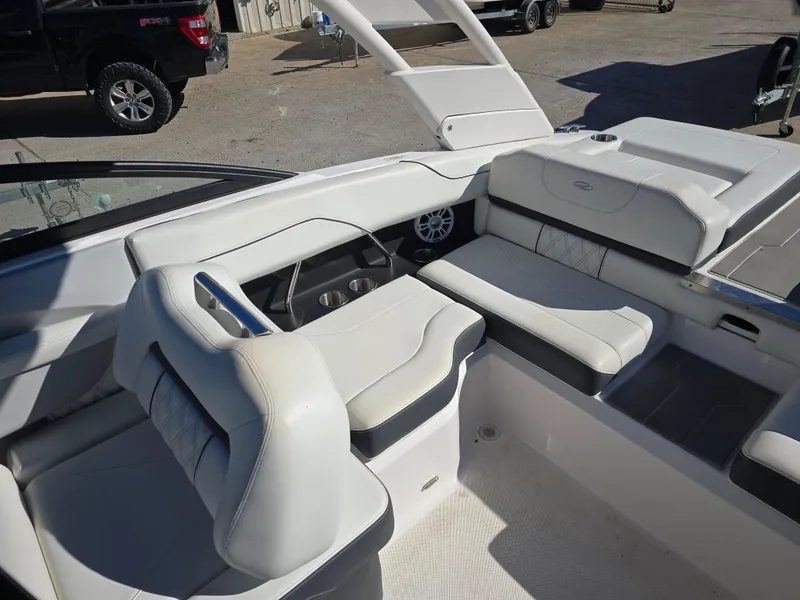 Slide: The Image of 2021 Regal LS2 boat interior with white leather seating and cup holders. - 11