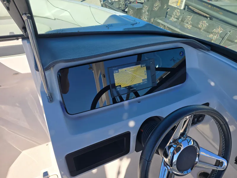 Slide: The Image of 2021 Regal LS2 boat dashboard with navigation screen and steering wheel. - 14