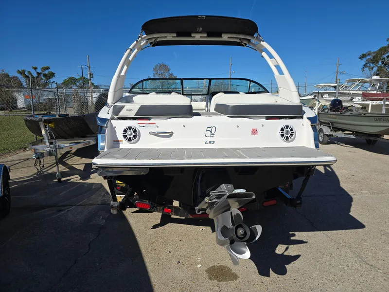 Slide: The Image of 2021 Regal LS2 boat, rear view, showcasing sleek design and powerful engine. - 19