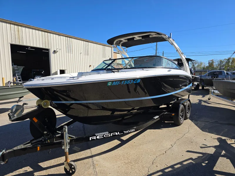 Slide: The Image of 2021 Regal LS2 boat on trailer, parked outside a warehouse. - 21