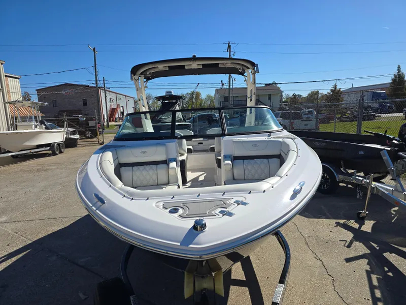 Slide: The Image of 2021 Regal LS2 boat with white interior, parked outdoors under clear blue sky. - 22