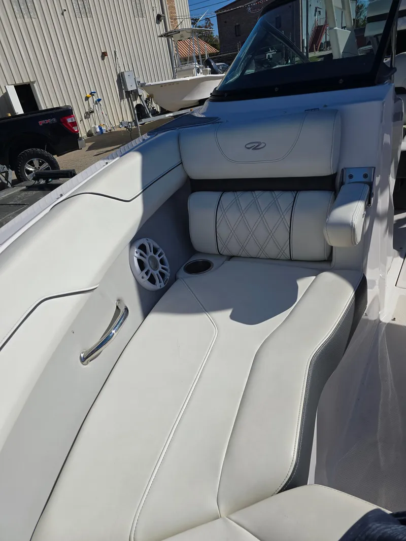Slide: The Image of 2021 Regal LS2 boat interior with white leather seating and speaker. - 5