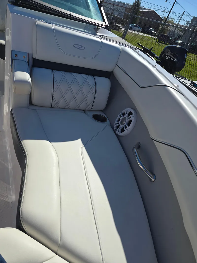 Slide: The Image of 2021 Regal LS2 boat interior with white leather seating and speaker. - 6