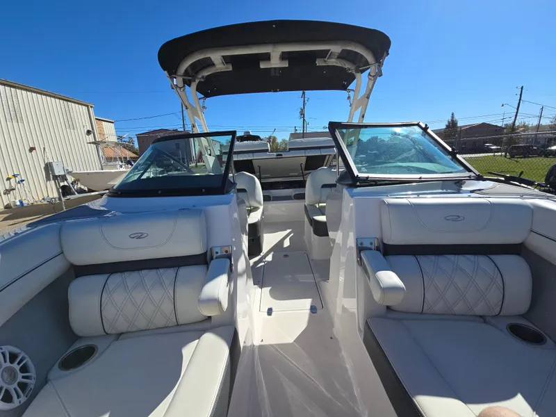Slide: The Image of 2021 Regal LS2 boat interior with white seating and black canopy. - 7