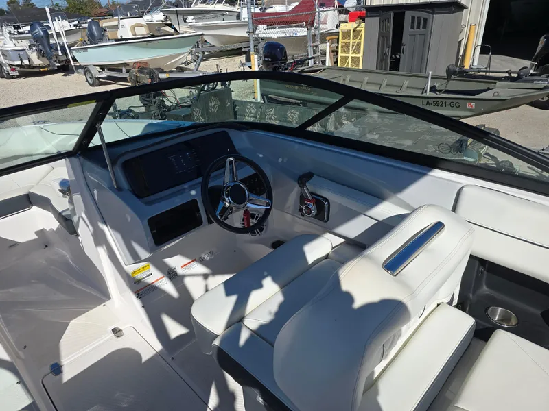 Slide: The Image of 2021 Regal LS2 boat interior with steering wheel and seating. - 9