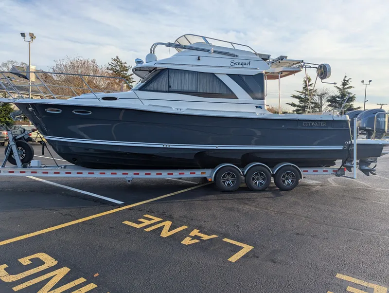 The Image of 2022 Cutwater C-32 CB boat on trailer in parking lot. - 1
