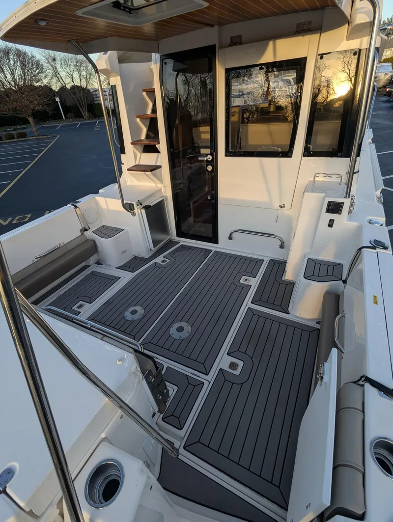Slide: The Image of 2022 Cutwater C-32 CB boat deck with modern seating and sleek design. - 17