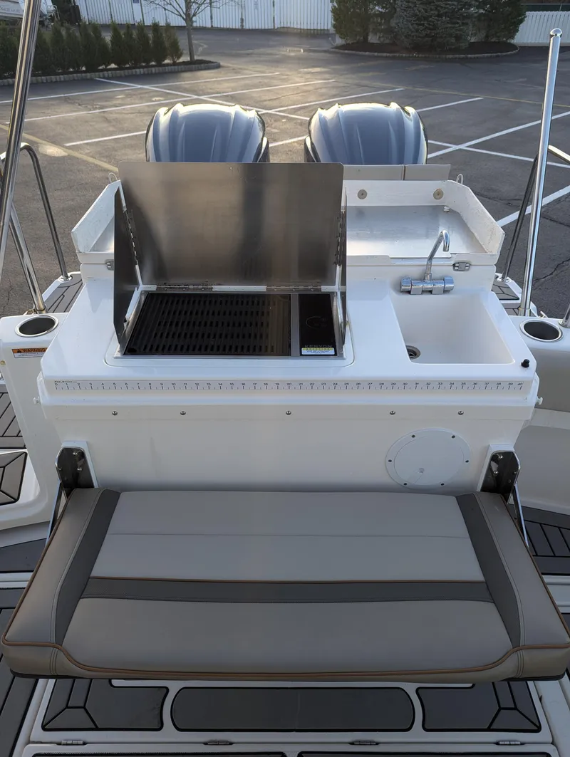Slide: The Image of 2022 Cutwater C-32 CB boat with outdoor grill and seating area. - 18