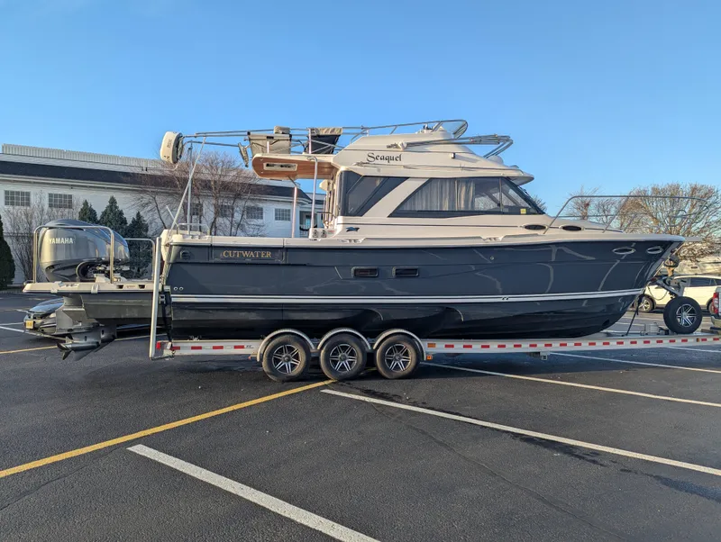 Slide: The Image of 2022 Cutwater C-32 CB boat on trailer in parking lot. - 2
