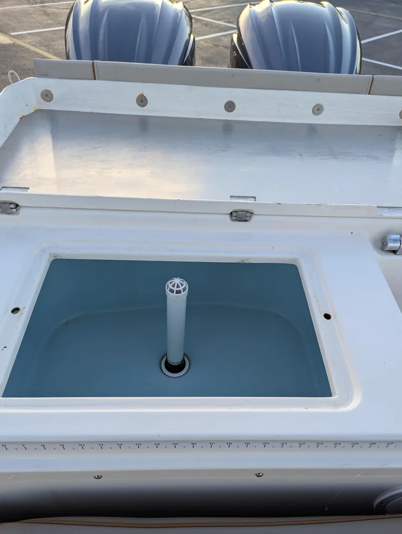 Slide: The Image of 2022 Cutwater C-32 CB boat livewell with dual outboard motors in background. - 20