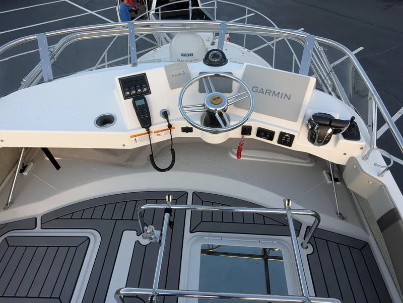 Slide: The Image of 2022 Cutwater C-32 CB helm with Garmin navigation, steering wheel, and control panel. - 27